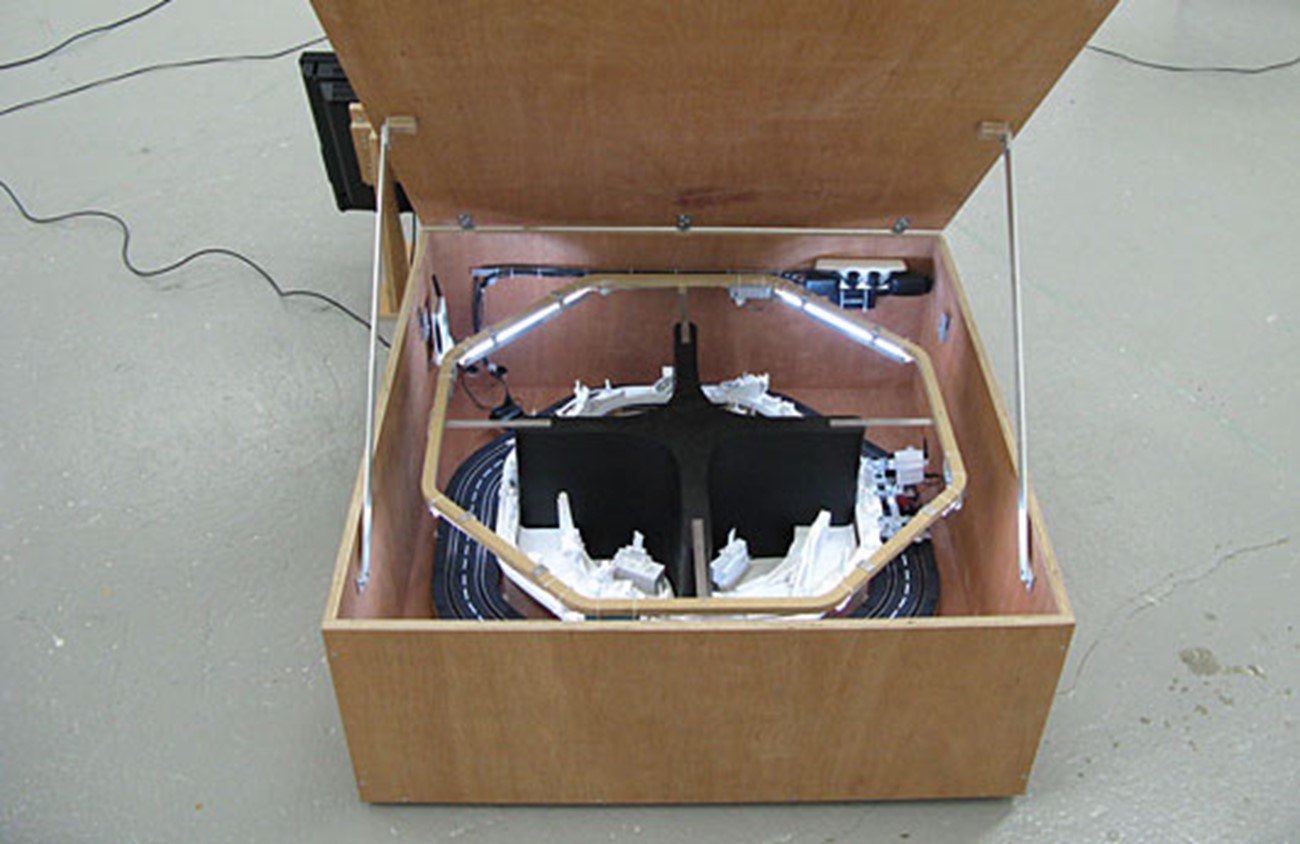 camera-based works — Landsskab efter hukommelse (Landscape according to memory). (1), 2008, Model train rails, camera mounted on cart, screen, aluminium and wood , Approx 200 x 100 x 100 cm (detail)