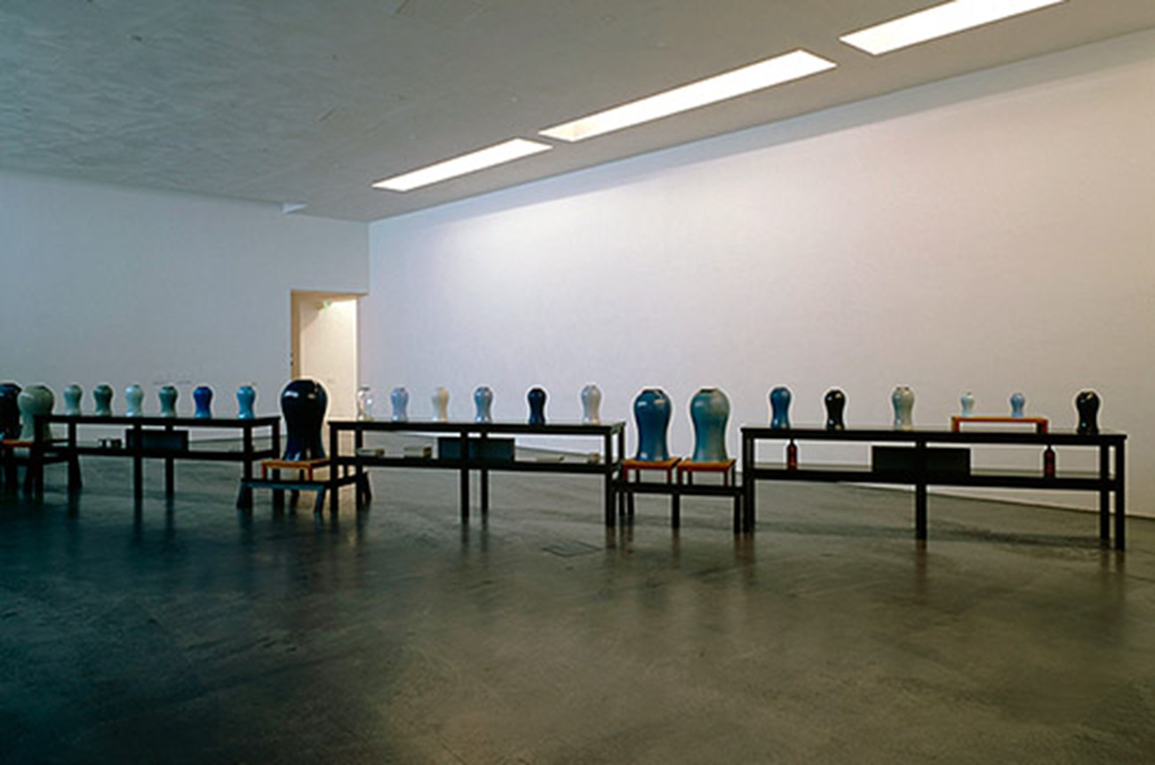 Installation — Installationview, Christian Skeel in collaboration w. Morten Skriver Babylon 1996 installation Collection: Kiasma Museum of Contemporary Art, Helsinki (Finland) Babylon is a scent-installation and consists of 29 vases placed in line on a row of tables. The vases contain scent oil. Among others, the scents cover tree and flower fragrances, the smell of tar plus animal and chemical scents. They are juxtaposed in order to accentuate the particularity of the single scent. Scents provoke memories from a lifetime to surface – the installation is a memory vehicle, so to speak. The vases are given form by Ursula Munch Petersen, Ole Jensen, Tora Urup and Inge Louise Bach and produced by Royal Copenhagen Porcelain Manufactory. Babylon is from 1996 and has been exhibited at Esbjerg Art Museum, Hessenhuis, Antwerpen (Belgium), Nicolaj - Copenhagen Contemporary Art Center, Kiasma Museum of Contemporary Art, Helsinki (Finland).