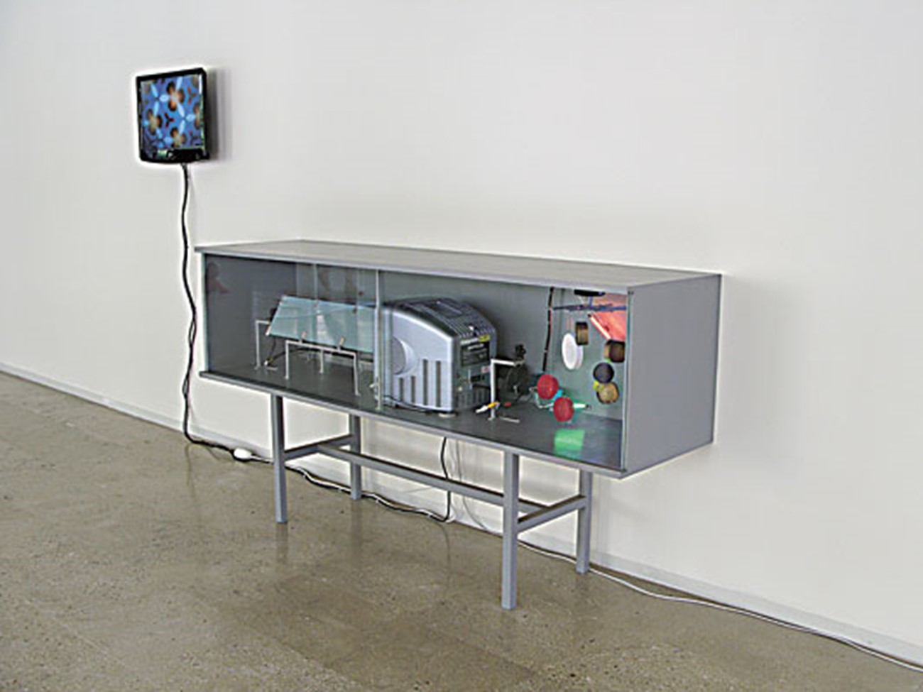 camera-based works — Anordning (Device), 2008, Wood, mirrors, plastic lits, camera, small monitor, engine, lightbulps , 60 x 67 x 180 cm