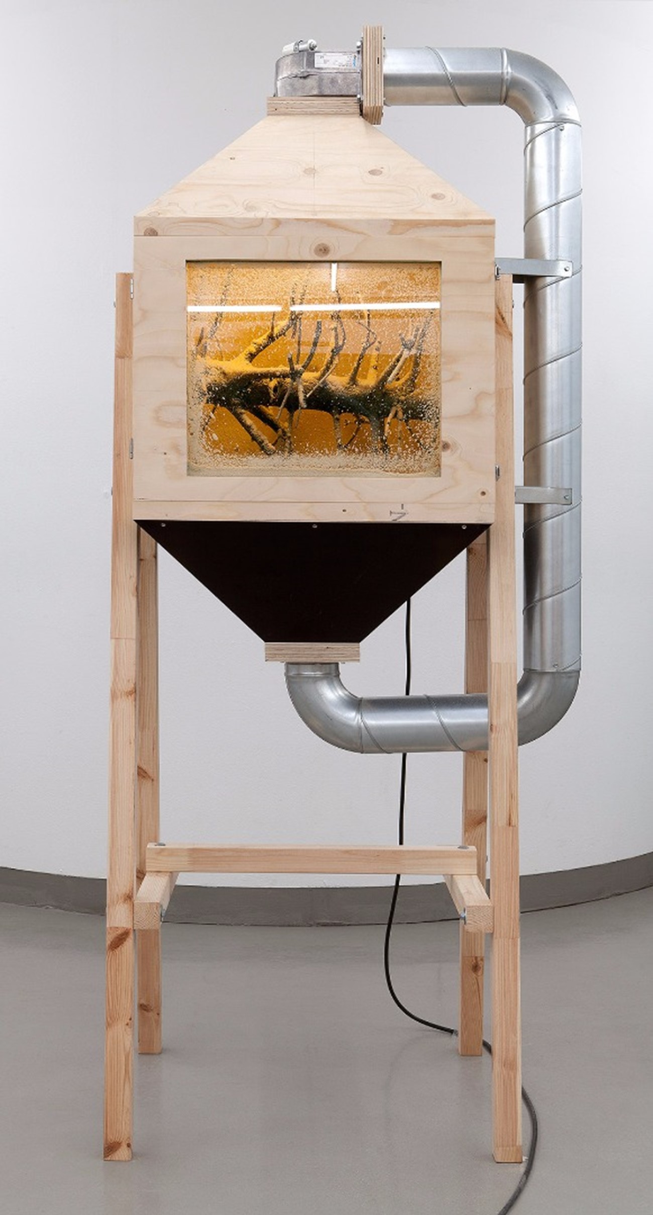 Savsmuldsinstrument (Saw Dust Instrument), 2012, Board, plywood, pine tree, saw dust, metal, ventilator, cable, 193 x 83 x 68 cm